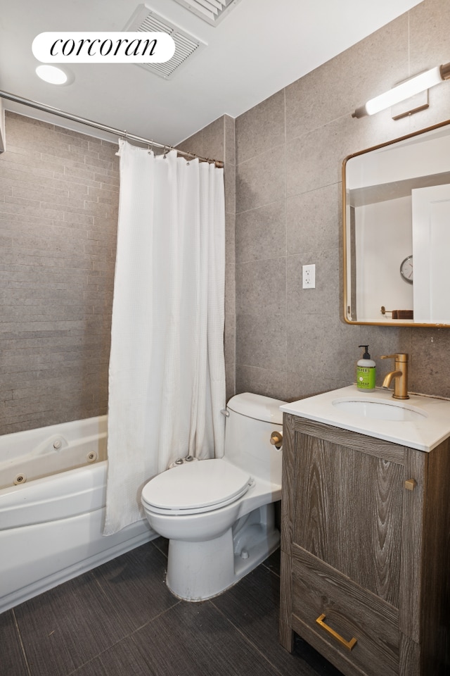 502 1st St Unit 1, New York City, NY 11215 - full bathroom featuring toilet, vanity, a combined bath / shower with jetted tub, and tile walls