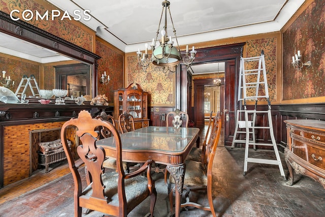 32 W 85th St, New York City, NY 10024 - dining space with a wainscoted wall, a chandelier, wallpapered walls, and crown molding