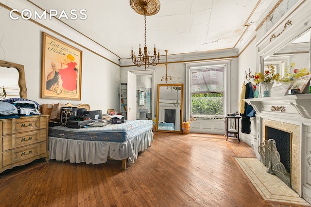 32 W 85th St, New York City, NY 10024 - bedroom with hardwood / wood-style flooring, a chandelier, crown molding, and a fireplace