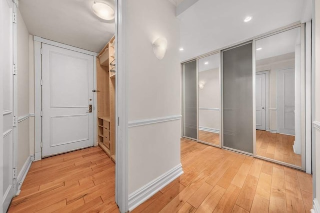 hall with recessed lighting, baseboards, and light wood-style flooring