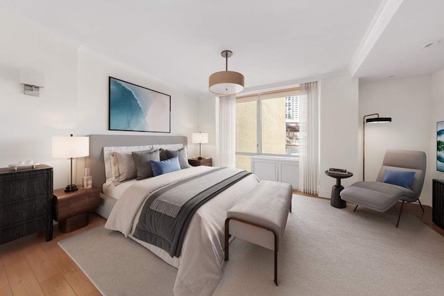 bedroom featuring light wood-type flooring and crown molding