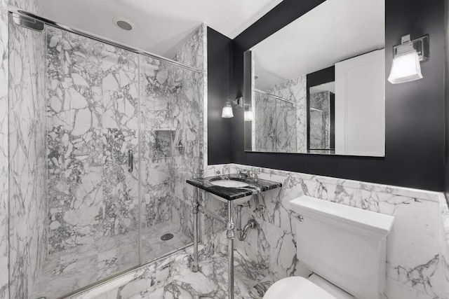 full bath with a sink, a marble finish shower, toilet, and marble finish floor