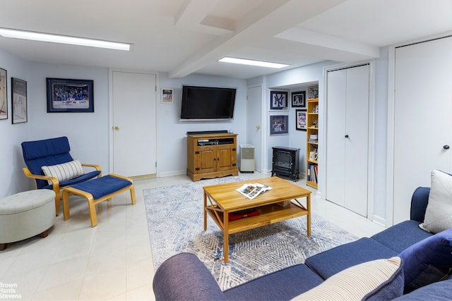 living area featuring baseboards and a wood stove