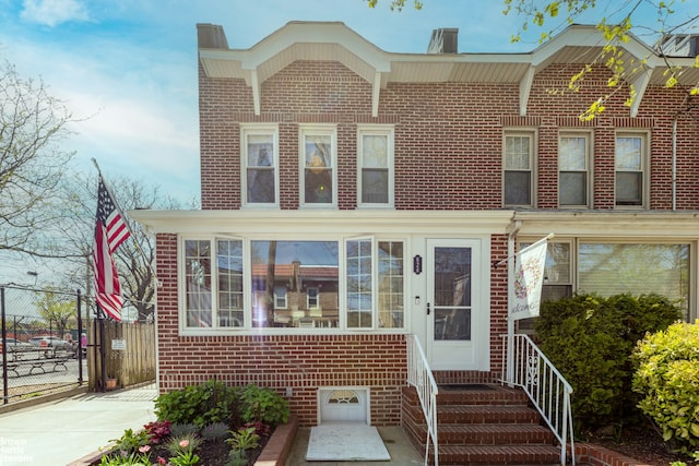 626 81st St, New York City, NY 11209 - townhome / multi-family property with brick siding, a chimney, and entry steps