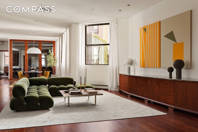 40 W 13th St Unit 2, New York City, NY 10011 - living area featuring healthy amount of natural light, wood finished floors, and a baseboard heating unit