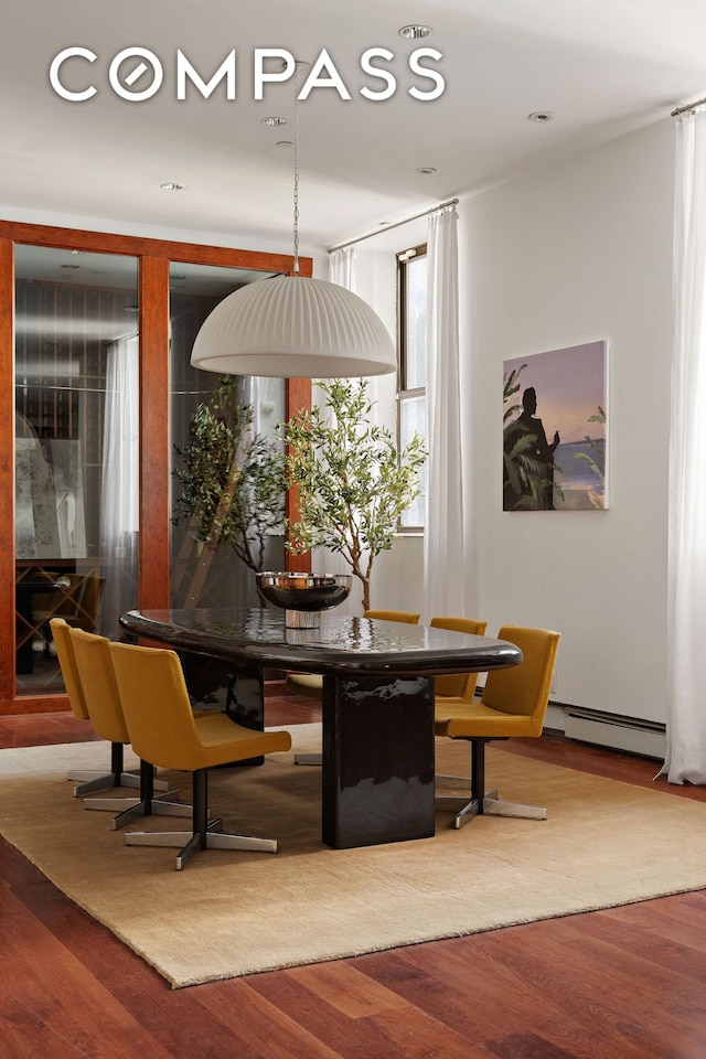 40 W 13th St Unit 2, New York City, NY 10011 - dining area featuring a baseboard heating unit and wood finished floors