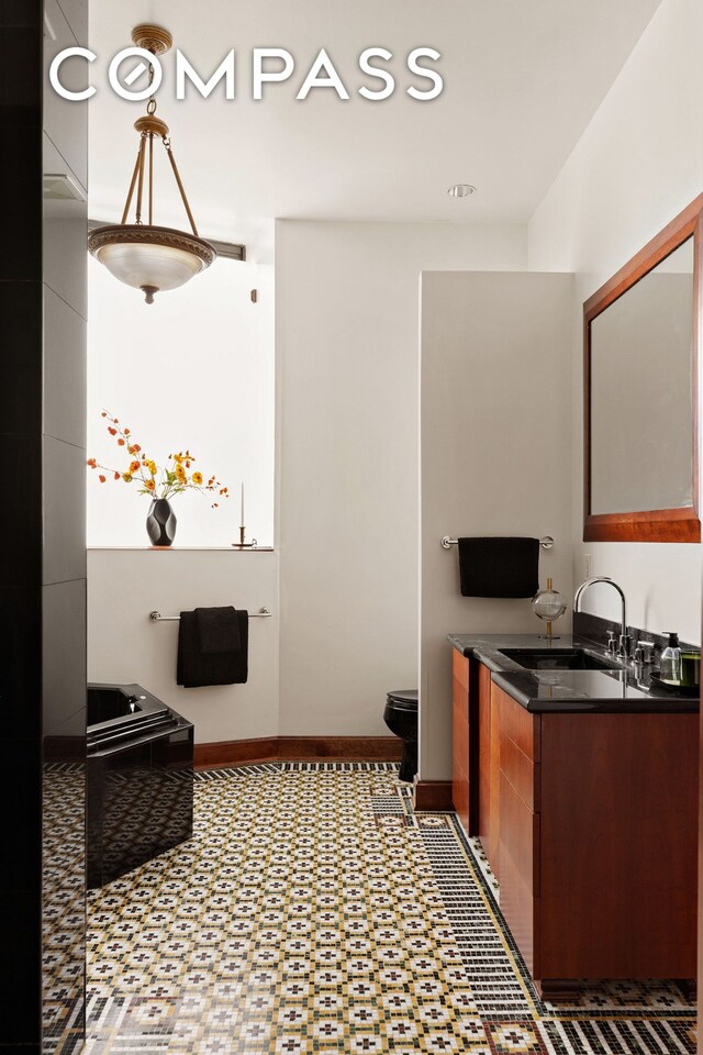 40 W 13th St Unit 2, New York City, NY 10011 - bathroom featuring baseboards, vanity, and toilet