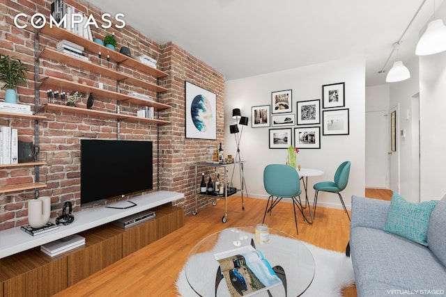 living area with light wood-type flooring and baseboards