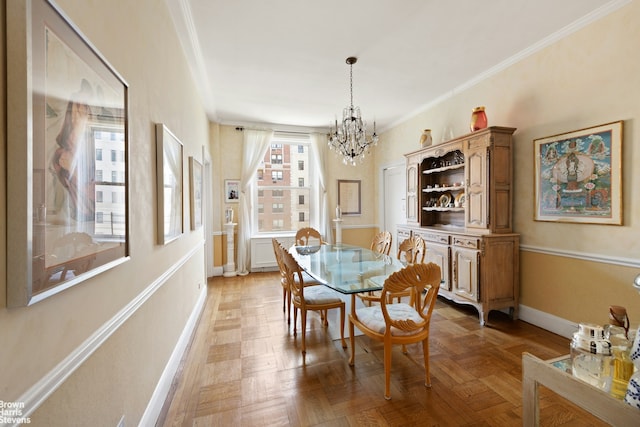 dining space with crown molding, baseboards, and an inviting chandelier