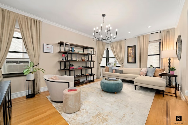 sitting room featuring baseboards, cooling unit, a chandelier, ornamental molding, and light wood-style flooring