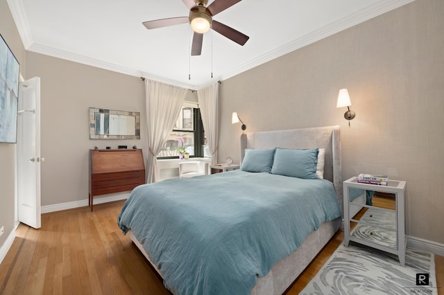bedroom featuring baseboards, ornamental molding, and wood finished floors