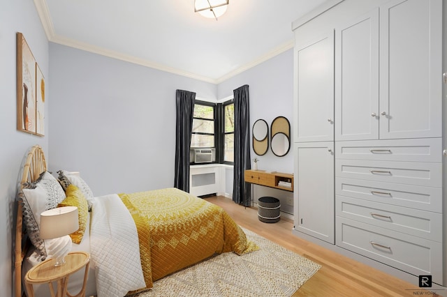 bedroom featuring crown molding, light wood-style flooring, and cooling unit