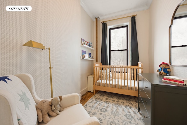 bedroom featuring visible vents, ornamental molding, and light wood-style floors