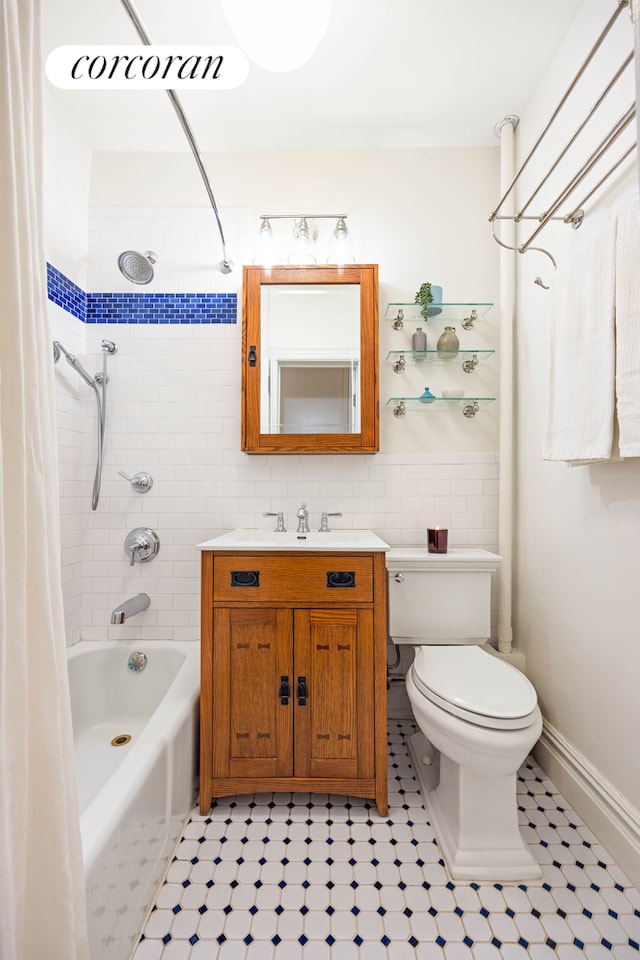 full bathroom featuring vanity, visible vents, toilet, tile walls, and shower / tub combo