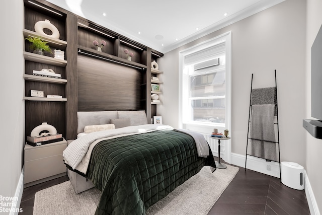 bedroom featuring crown molding and baseboards