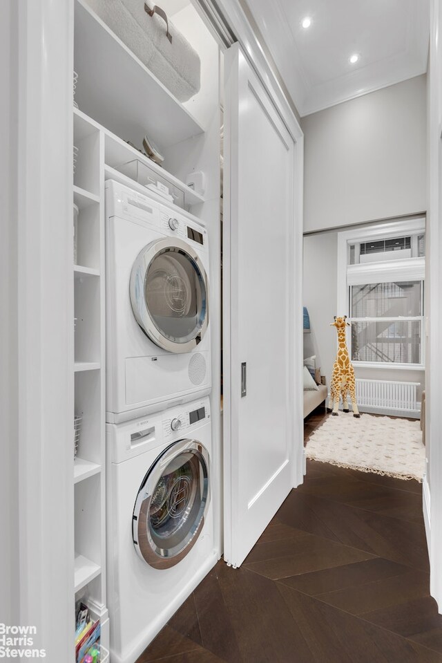 140 W 69th St Unit 812, New York City, NY 10023 - laundry area featuring stacked washing machine and dryer, crown molding, and recessed lighting