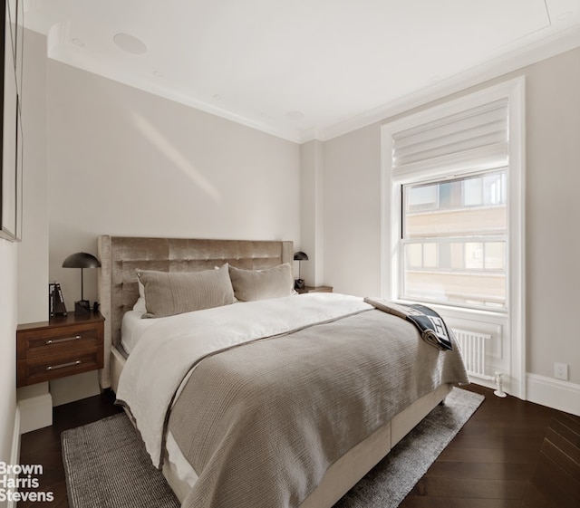 bedroom featuring ornamental molding and dark wood-type flooring