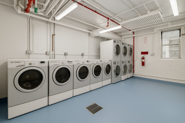 community laundry room featuring separate washer and dryer and visible vents