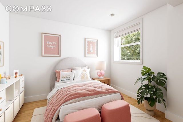 bedroom featuring baseboards and light wood-style floors