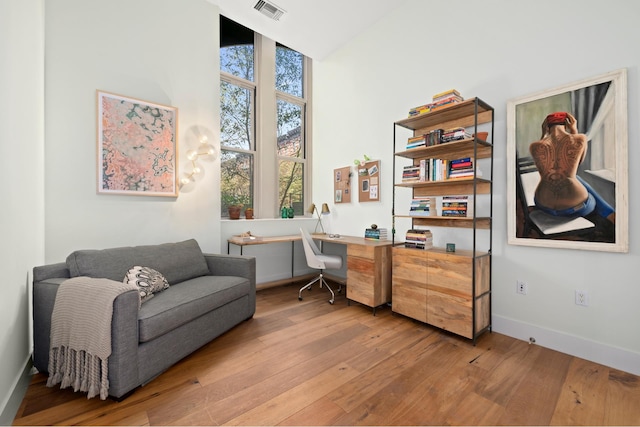 220 W 148th St Unit 1L, New York City, NY 10039 - office area featuring light wood finished floors, baseboards, and built in desk