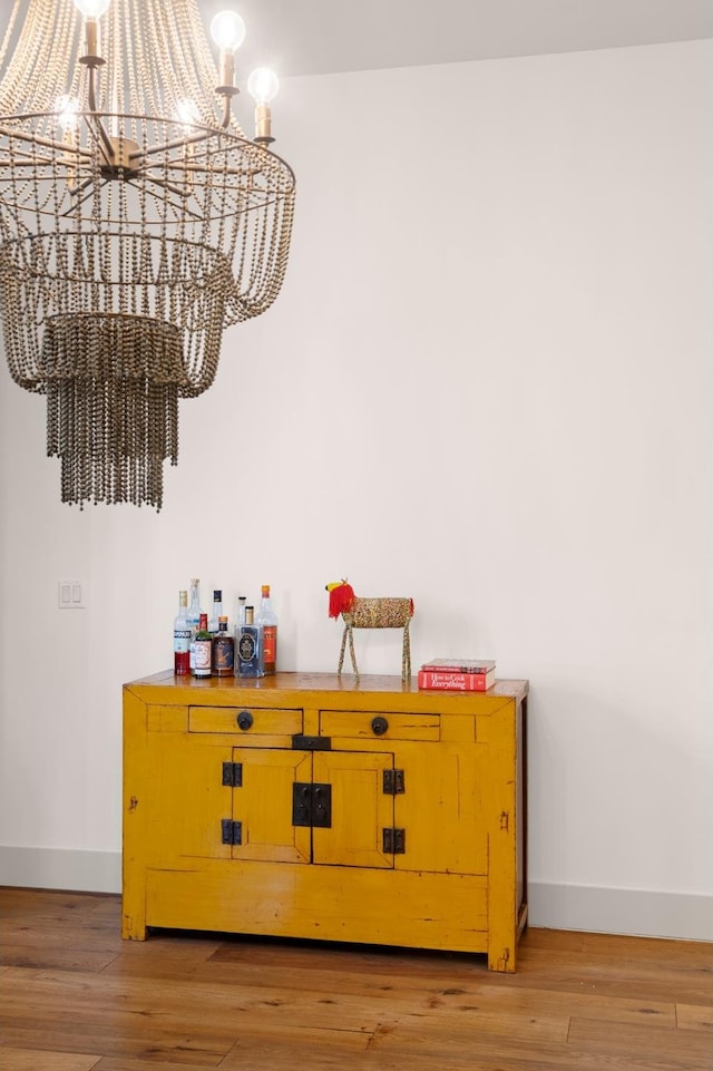 220 W 148th St Unit 1L, New York City, NY 10039 - detailed view of a chandelier, baseboards, and wood finished floors