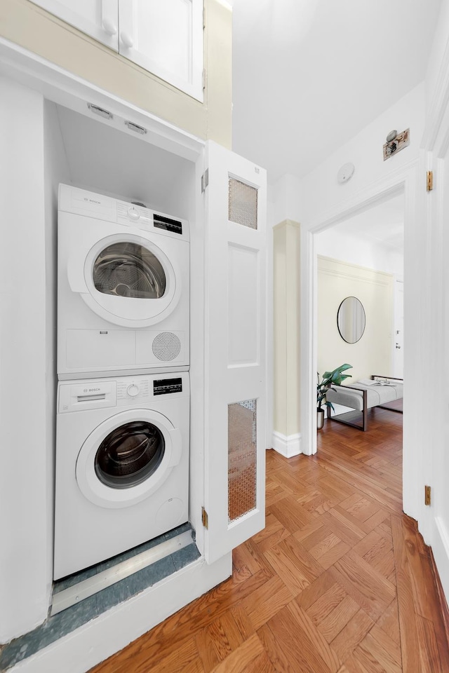 505 W End Ave Unit 2-B, New York City, NY 10024 - laundry room with stacked washer and clothes dryer and baseboards
