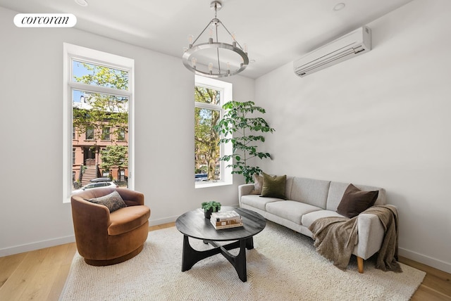 291 6th Ave Unit 4, New York City, NY 11215 - living area with a wall unit AC, wood finished floors, a chandelier, and baseboards