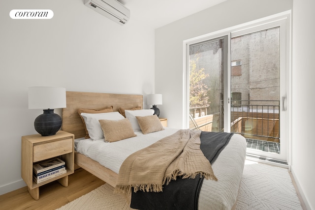 291 6th Ave Unit 4, New York City, NY 11215 - bedroom with a wall unit AC, access to exterior, wood finished floors, and baseboards