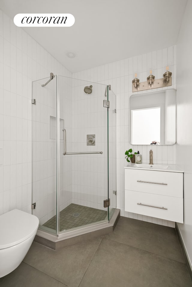 291 6th Ave Unit 4, New York City, NY 11215 - full bathroom with a stall shower, toilet, vanity, and tile patterned floors