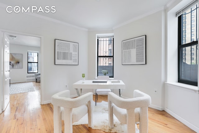 305 W 143rd St Unit 2, New York City, NY 10030 - home office featuring healthy amount of natural light, light wood-style flooring, radiator heating unit, and crown molding