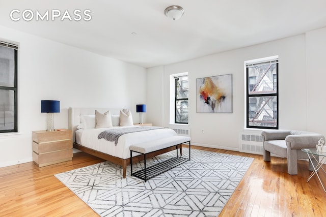 305 W 143rd St Unit 2, New York City, NY 10030 - bedroom with wood-type flooring and radiator