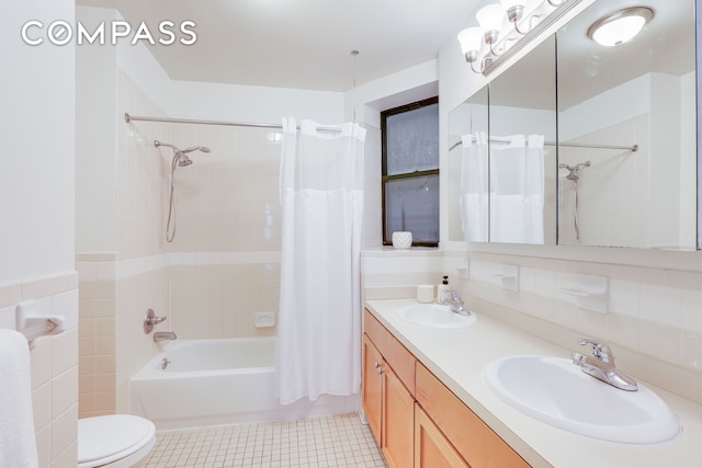 305 W 143rd St Unit 2, New York City, NY 10030 - full bathroom featuring shower / bath combo with shower curtain, double vanity, and tile patterned flooring