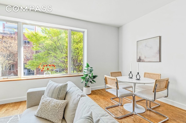 dining area featuring baseboards and wood finished floors