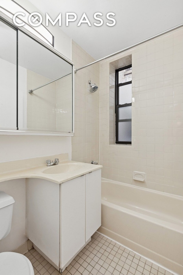 bathroom featuring tile patterned flooring, toilet, washtub / shower combination, and vanity