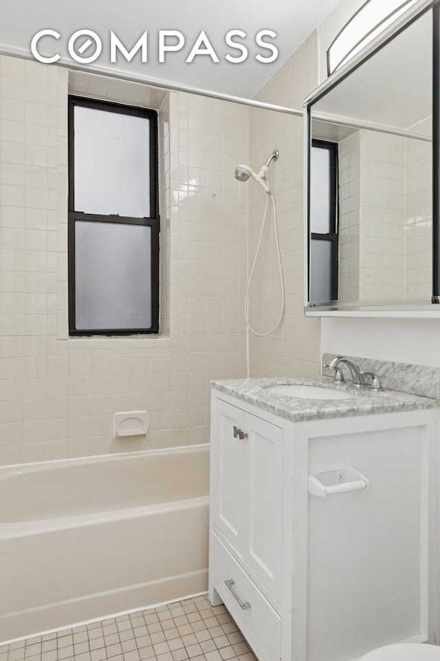 bathroom featuring tile patterned floors, shower / washtub combination, and vanity