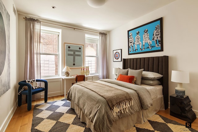 bedroom with baseboards and wood finished floors