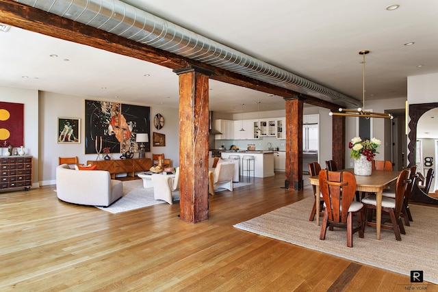 dining area featuring decorative columns, recessed lighting, and light wood-style flooring