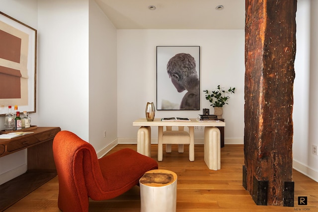 office area with light wood-style floors and baseboards