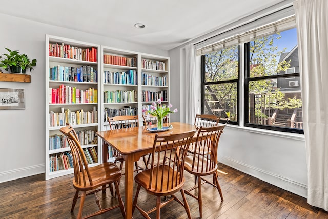 dining room with baseboards and hardwood / wood-style flooring