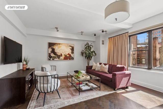 living room featuring visible vents, baseboards, and wood finished floors