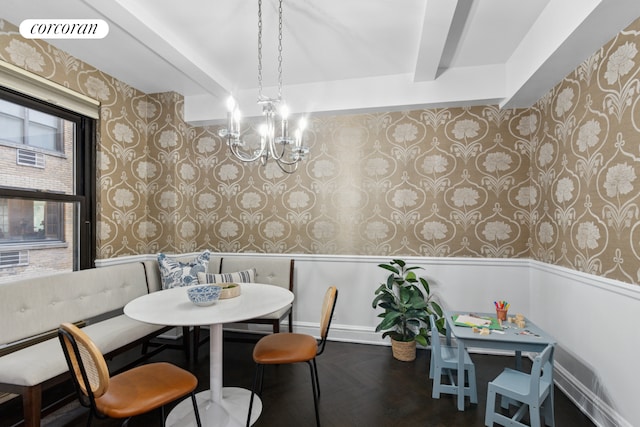 dining room featuring an inviting chandelier, wainscoting, breakfast area, wallpapered walls, and visible vents