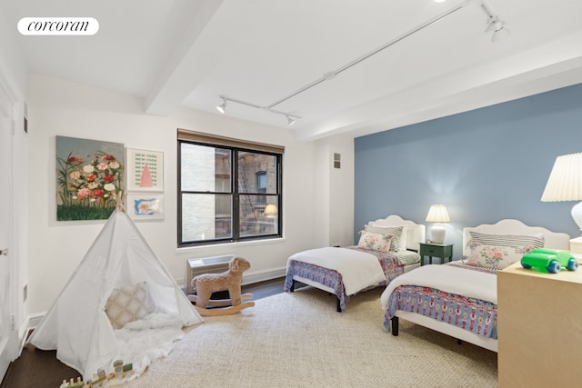 bedroom with track lighting, wood finished floors, and visible vents