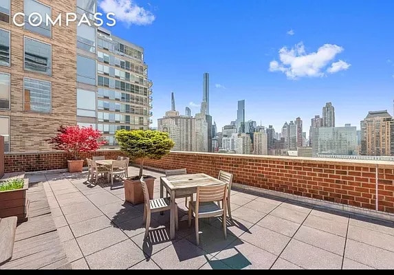 view of patio / terrace featuring a city view and outdoor dining area