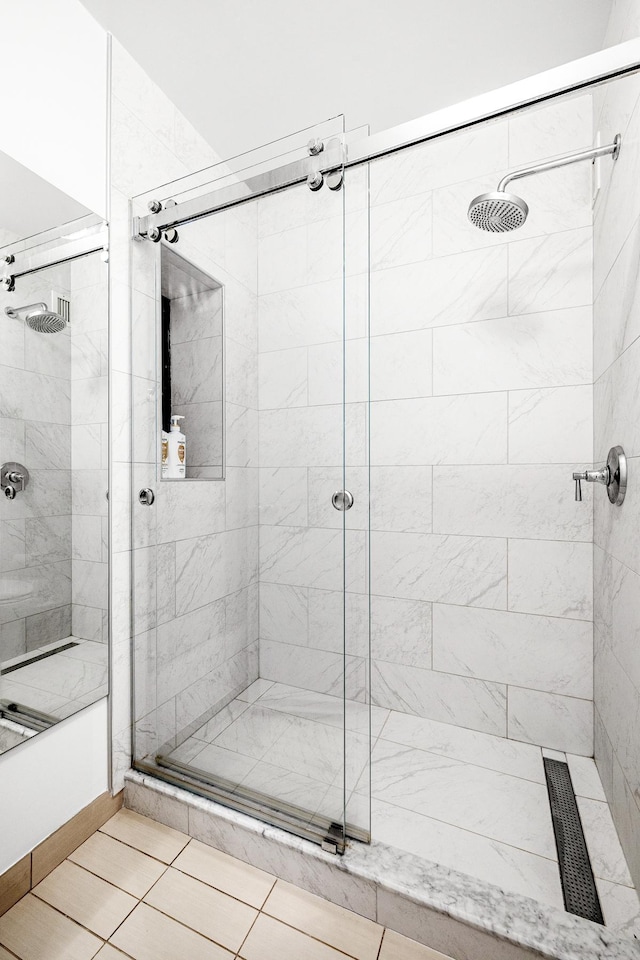 bathroom with tile patterned flooring and a stall shower