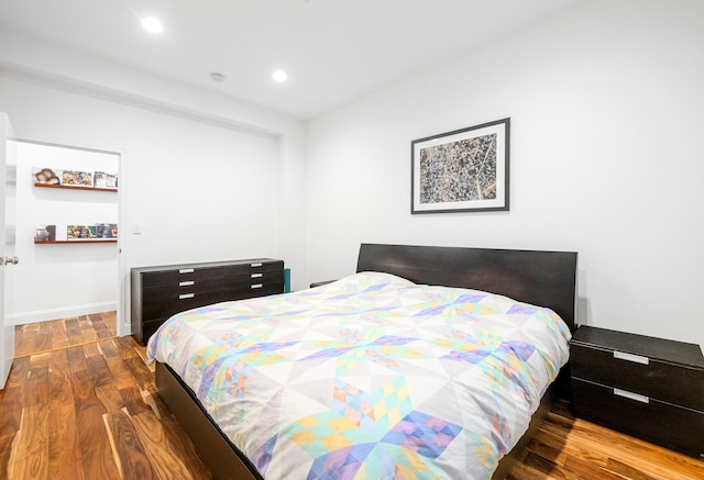 bedroom with baseboards, recessed lighting, and wood finished floors