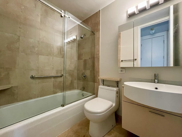bathroom with toilet, enclosed tub / shower combo, and vanity