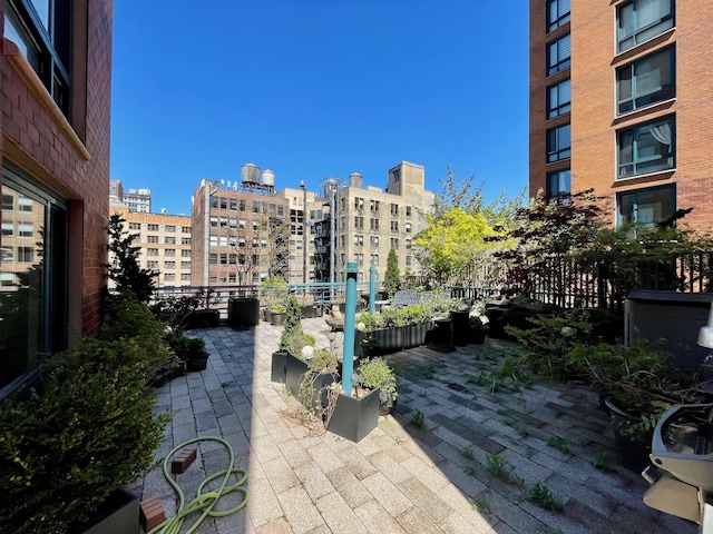 surrounding community with a patio, a view of city, and fence