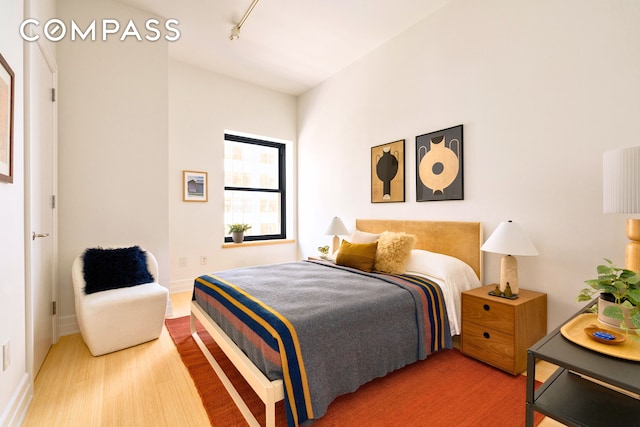 110 Livingston St Unit 6C, New York City, NY 11201 - bedroom with track lighting, wood finished floors, and baseboards