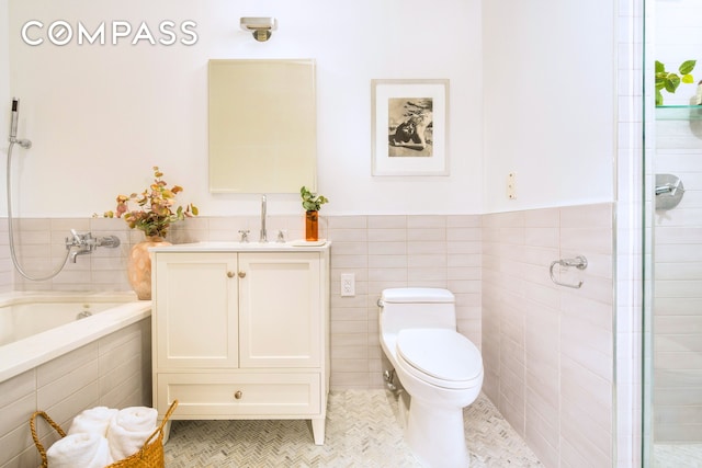 110 Livingston St Unit 6C, New York City, NY 11201 - full bathroom featuring tile patterned flooring, vanity, a bath, tile walls, and toilet