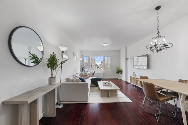 60 E 8th St Unit 11D, New York City, NY 10003 - living room with wood-type flooring, baseboards, and an inviting chandelier